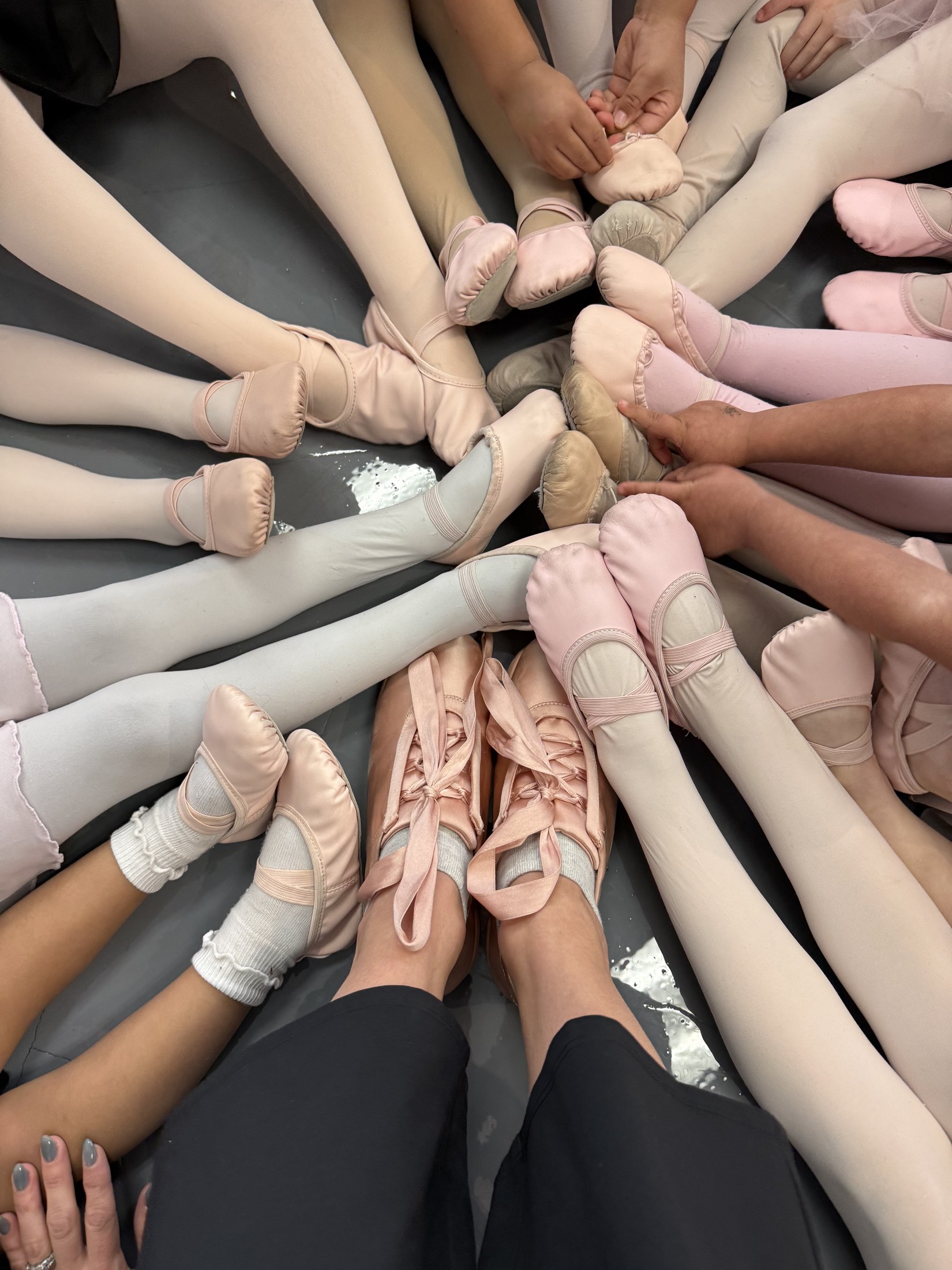 Dancers make a circle with their feet before class