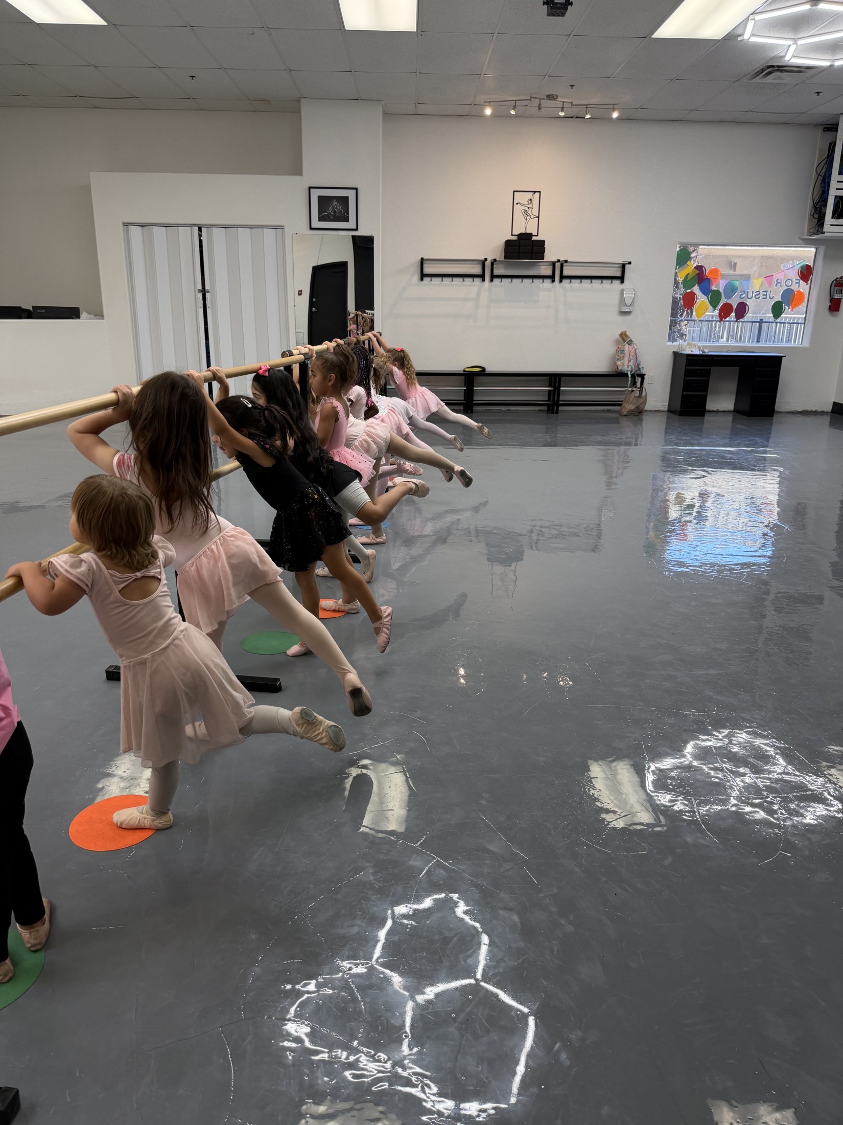 A close moment of dancers helping one another get ready