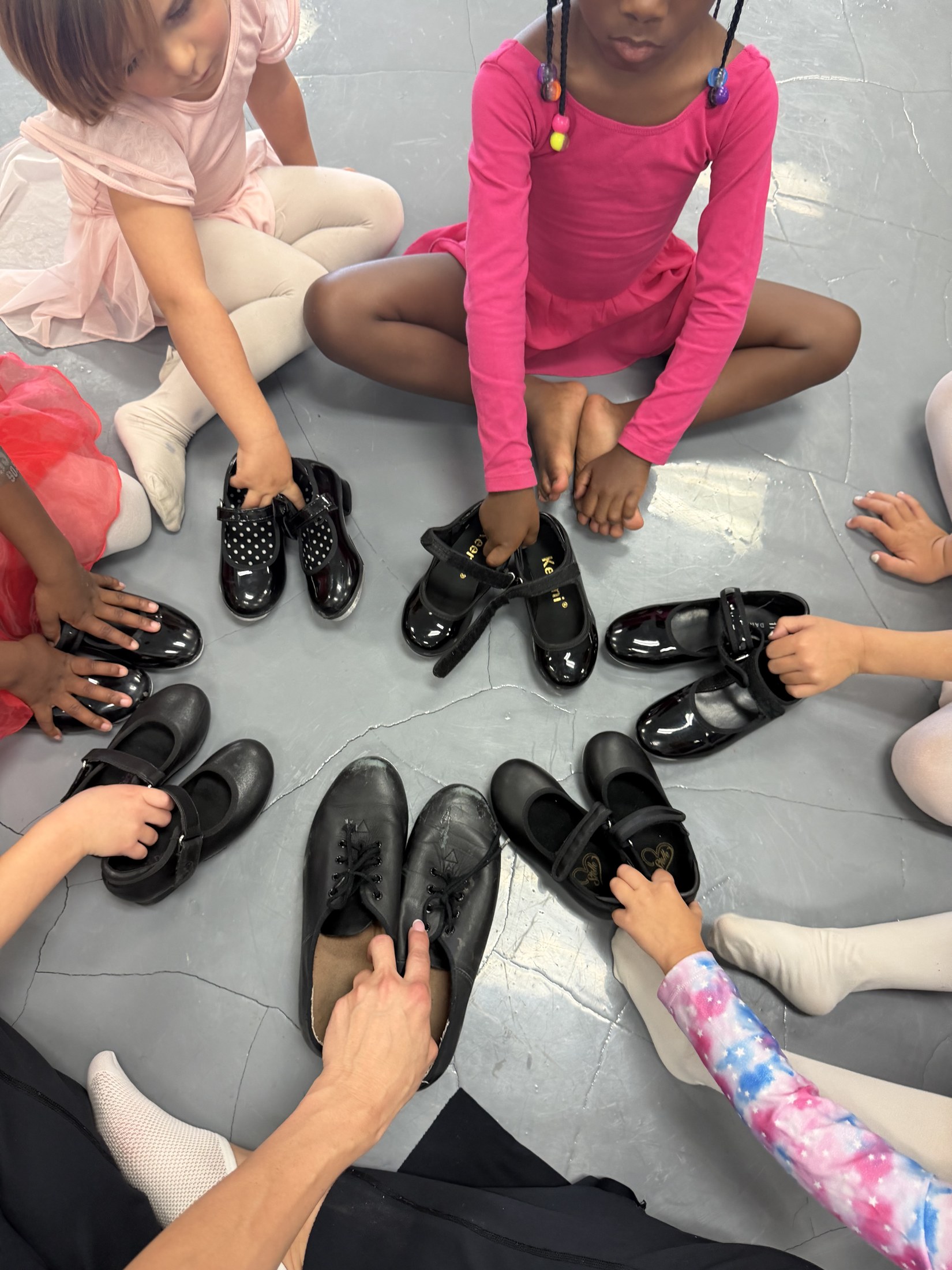 Students help one another get ready to dance