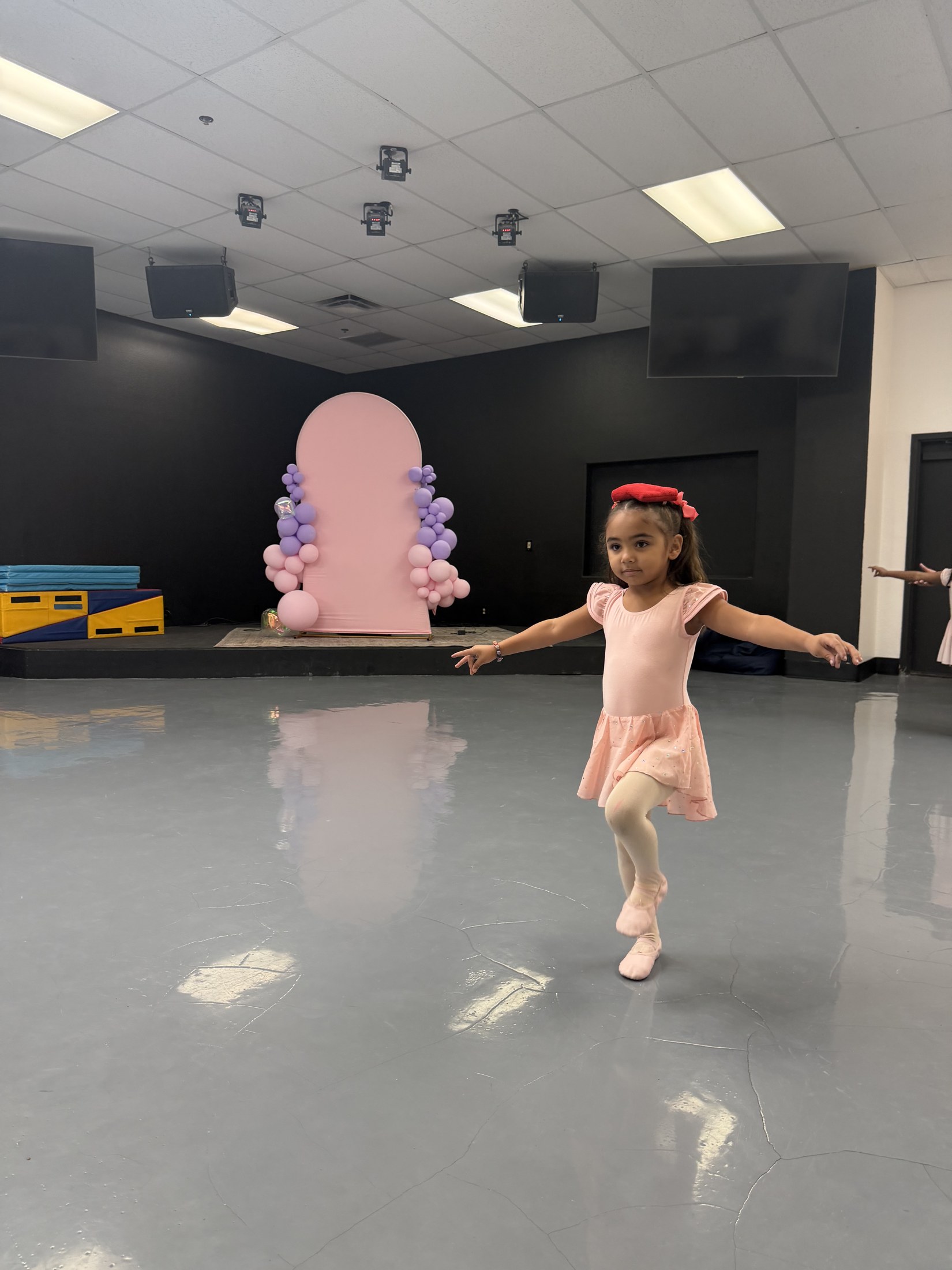 Two young dancers sharing a moment after class